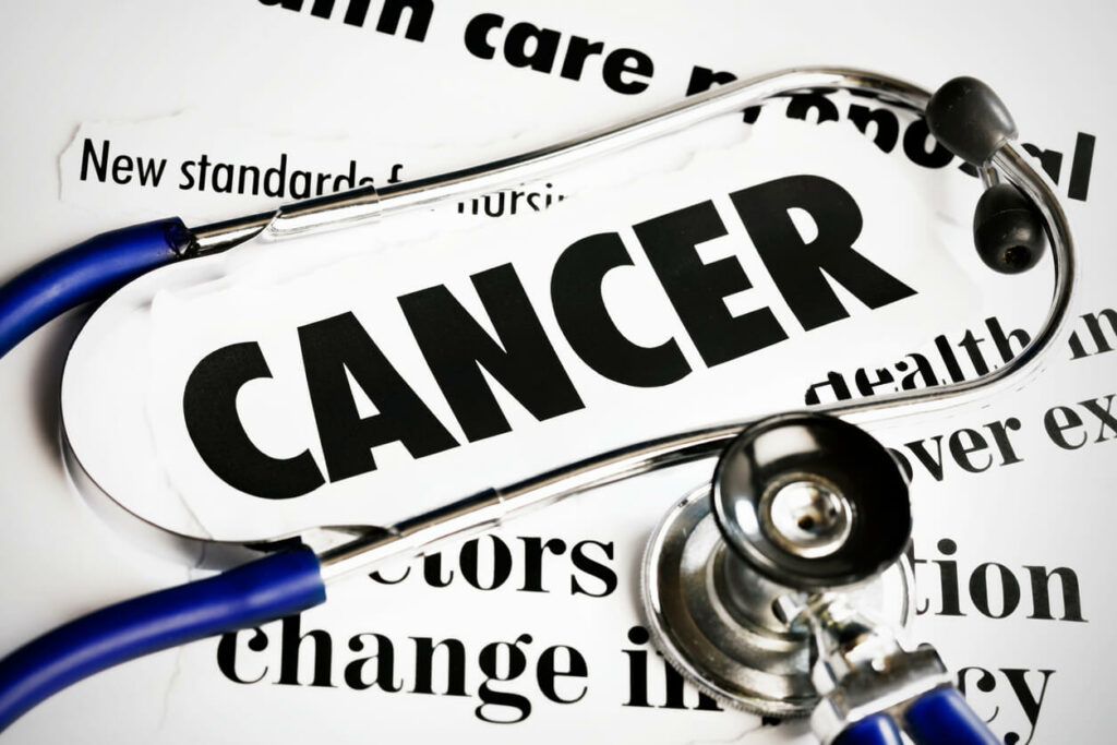 Stethoscope lying on Cancer headlines.