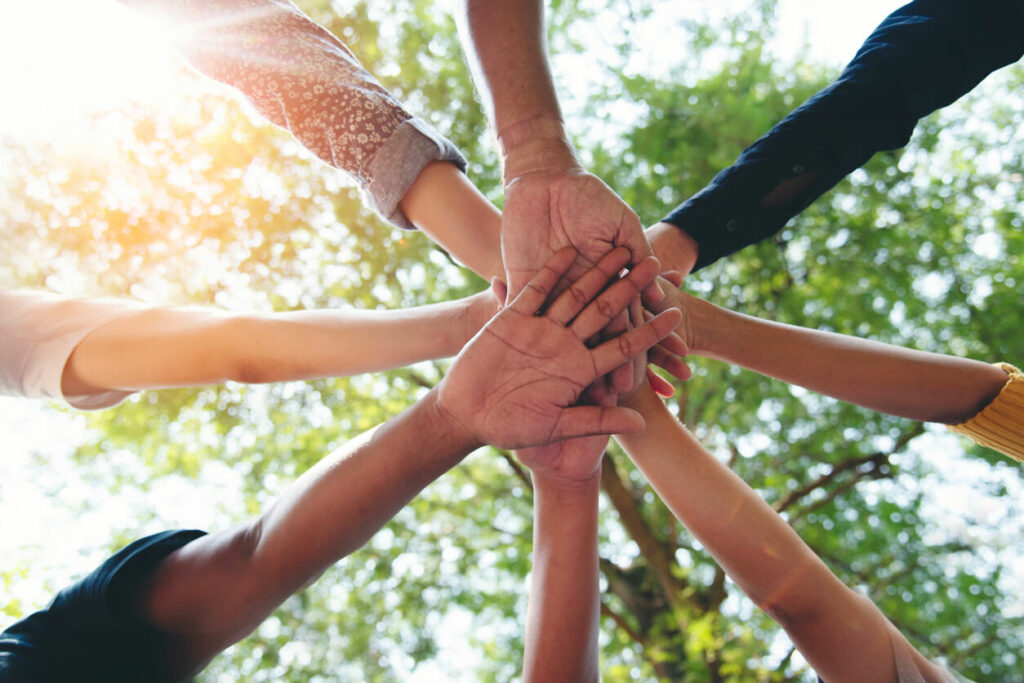 A group of people joined hands to represent a Cancer Help Organization.