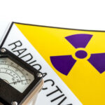 An image of a hand-held radiation survey meter detecting radiation exposure linked to cancer.
