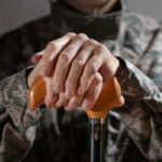 atomic veteran in camouflage uniform holding a cane