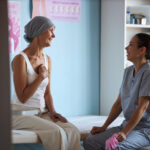 Middle Aged Woman with Cancer Consulting Female Medical Professional.